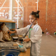 Child plays veterinarian with stuffed animal